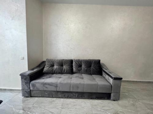 a leather couch sitting in a room next to a wall at Arcadia Adelina in Odesa