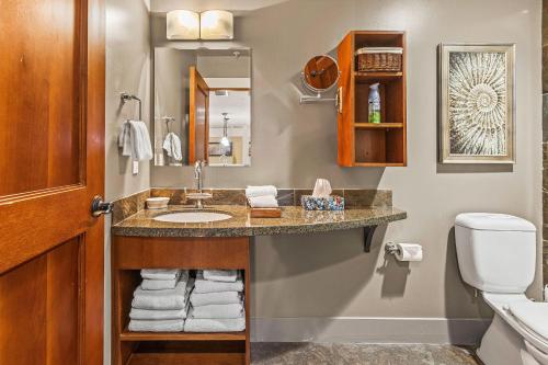 a bathroom with a sink and a toilet at Rockies Retreat by Canadian Rockies Vacation Rentals in Canmore