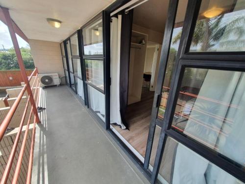 an empty hallway of a house with glass doors at Ascot Epsom Motel in Auckland
