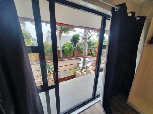 an open door with a view of a balcony at Ascot Epsom Motel in Auckland