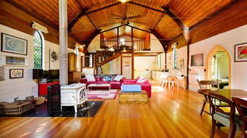 a living room with a couch and a stove at Blue Gum Church - Artistic Retreat in Beechworth