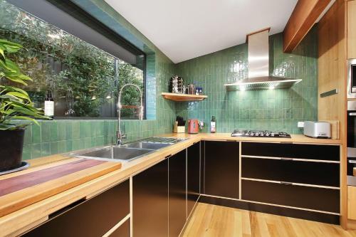 a kitchen with a sink and a window at Millie & Pips Beechworth Bungalow in Beechworth