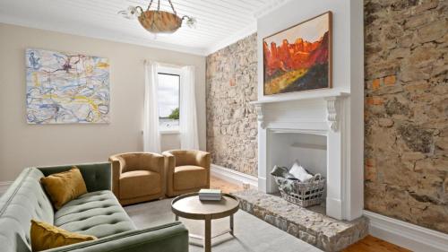 a living room with a couch and a fireplace at 1858 - The Prospect in Beechworth
