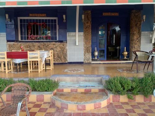 a table and chairs in front of a building at AMRAOUI Apartment in Rissani