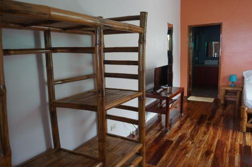 a room with two bunk beds and a desk at Marianita's cottages in Mambajao