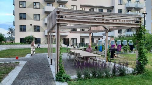 a picnic table in front of a building at Stockholm Private Rooms in Shared Lovely, Amazing, Modern Apartment +Garden +BBQ in Stockholm