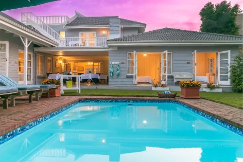 a swimming pool in front of a house at The Knysna Belle Guest House in Knysna