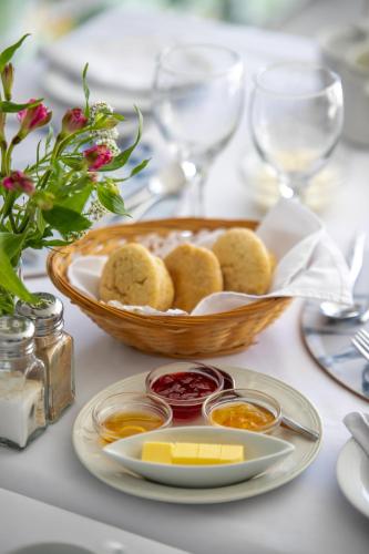 a table with a plate of food and a bowl of dips at The Knysna Belle Guest House in Knysna