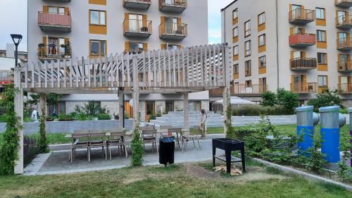 a wooden bridge in front of a building at Stockholm Private Rooms in Shared Lovely, Amazing, Modern Apartment +Garden +BBQ in Stockholm