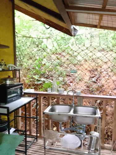 a kitchen with a sink and a counter with a window at Camp Talusi Hilltop Overlooking in El Nido