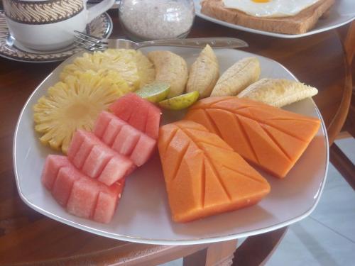 a plate of fruits and vegetables on a table at Tambun Sari Beach Homestay in Amed