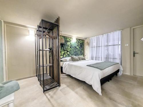a bedroom with a large bed and a large window at LOFT Centre Ville 2 Parking in Toulon