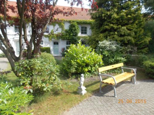 a park bench sitting in front of a house at Landhaus Kyritz in Kyritz
