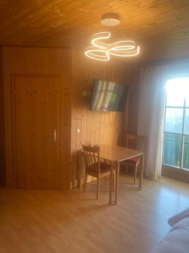 a dining room with a table and a window at Pension Maximilian in Gamlitz
