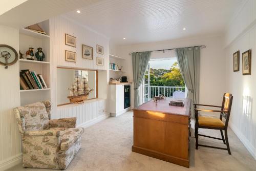 a living room with a desk and a chair at The Knysna Belle Guest House in Knysna