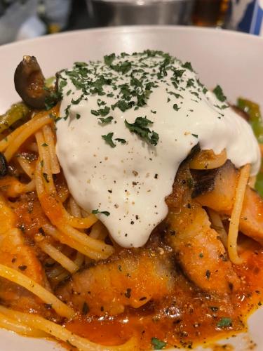 a plate of food with pasta and sauce and cheese at Mash Cafe & Bed NAGANO in Nagano