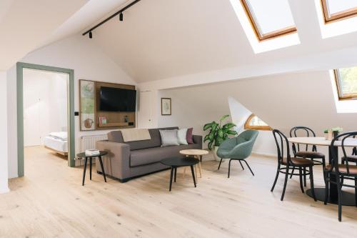 a living room with a couch and chairs and a table at Bio-Hotel Schani Wienblick in Vienna