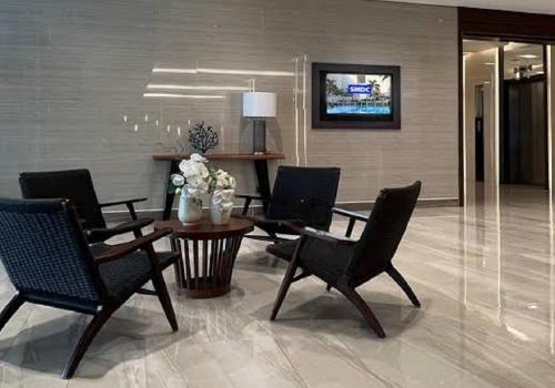 a lobby with chairs and a table in a building at CozyCoastStay by APPLETRAVELBEYONDPH in Manila