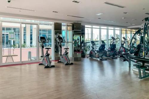 a gym with treadmills and ellipticals in a building at Studio in Al Furjan - Near Metro Dubai & Expo 2020 in Dubai