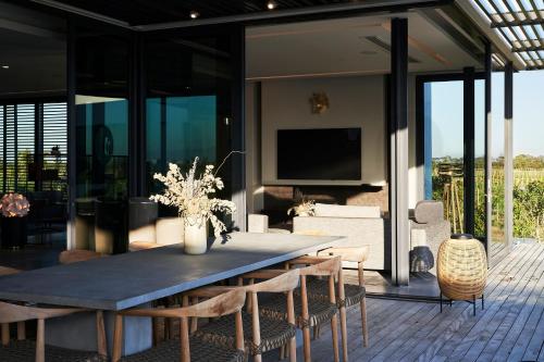 a dining room with a table and chairs at Vergenoegd Löw Boutique Hotel & Spa in Cape Town