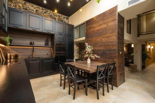 a kitchen with a wooden wall with a table and chairs at LOFT Centre Ville 2 Parking in Toulon