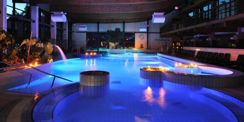 a large swimming pool with lights in a building at Apartma Ob Krki in Straža