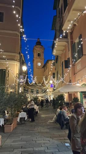 a city street with a clock tower in the background at Magici ricordi-Bordighera in Bordighera