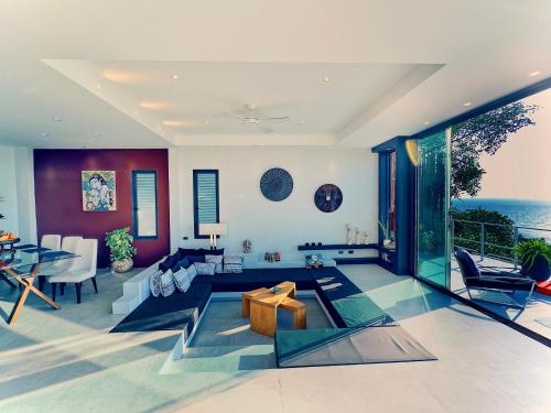 a living room with a view of the ocean at VILLA TSAY - Nature, Privacy, Elegance in Haad Yao