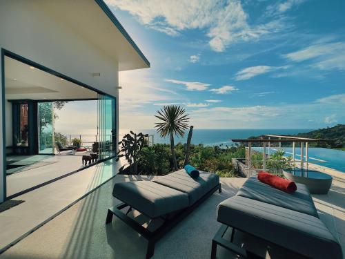 a balcony of a house with a view of the ocean at VILLA TSAY - Nature, Privacy, Elegance in Haad Yao