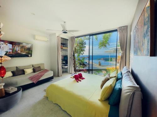 a bedroom with a large bed and a large window at VILLA TSAY - Nature, Privacy, Elegance in Haad Yao
