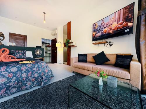 a living room with a bed and a couch at VILLA TSAY - Nature, Privacy, Elegance in Haad Yao