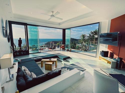 a living room with a view of the ocean at VILLA TSAY - Nature, Privacy, Elegance in Haad Yao