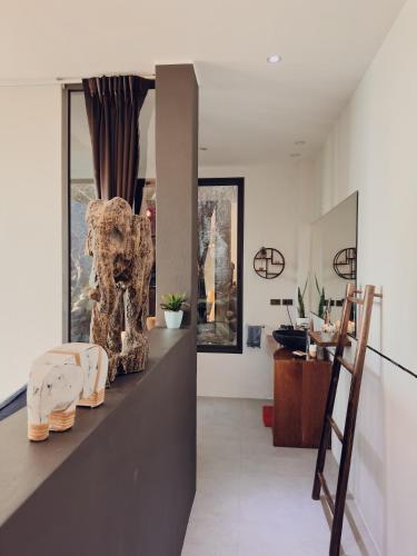 a living room with a counter withartifacts on it at VILLA TSAY - Nature, Privacy, Elegance in Haad Yao