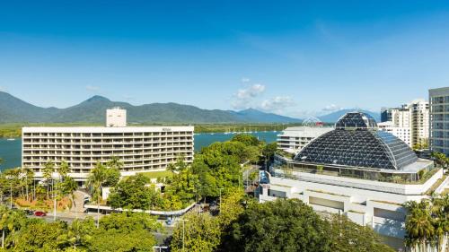 a view of a city with mountains in the background at Pacific Hotel Cairns in Cairns