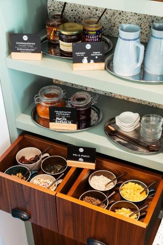 a shelf filled with lots of different types of food at Bio-Hotel Schani Wienblick in Vienna