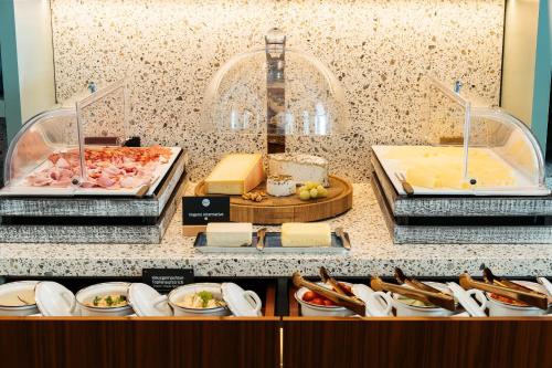 a buffet with cheese and other foods on a counter at Bio-Hotel Schani Wienblick in Vienna