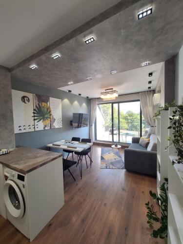 a living room with a couch a table and a washing machine at Cloud 6 -Top Center,360° view,Free private parking in Plovdiv
