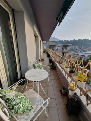 a balcony with a table and chairs and a view at Charming Penthouse near Como lake in Chiasso