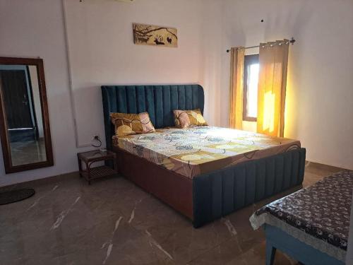 a bedroom with a large bed in a room at Private room in Retreat by Walias Farm Stay in Sohna
