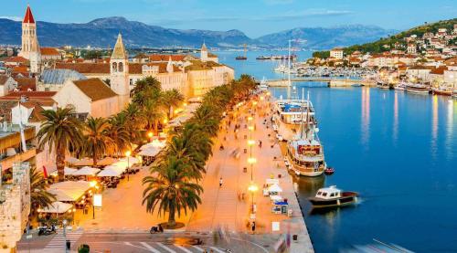 a city with a harbor and boats in the water at Luxury apartment Cairos in Trogir