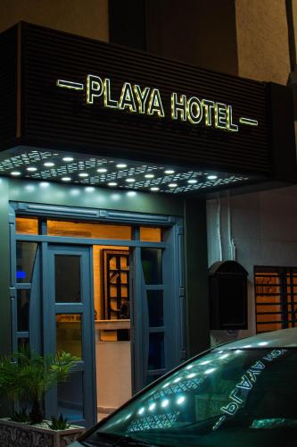a hotel with a car parked in front of it at PLAYA Hôtel & Restaurant Dakhla in Dakhla