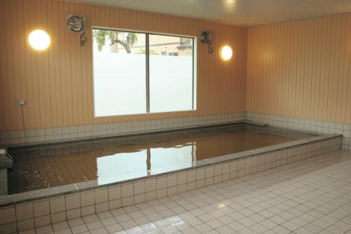 a pool of water in a room with a window at Kobohudonoyu in Sukagawa