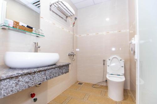 a bathroom with a sink and a toilet at Dong Do Airport Hotel in Ho Chi Minh City