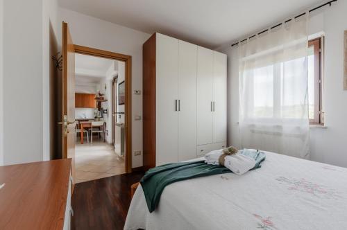 a bedroom with a bed and a large window at Perugia Quiet & Comfy Apartment in San Martino in Campo