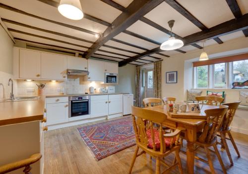 a kitchen and dining room with a table and chairs at Lyncroft in Aysgarth