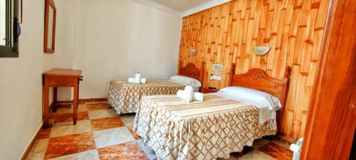 Postel nebo postele na pokoji v ubytování Hotel Virgen de los Reyes