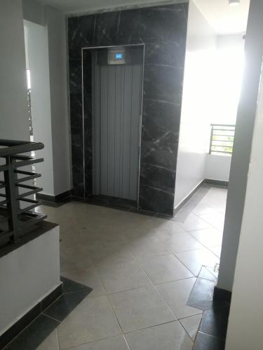 a hallway with a door and a tile floor at Carlyle comfort home in Thika