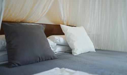 a bed with two pillows on top of it at ABBAZIA SS. QUIRICO E GIULITTA in Micigliano