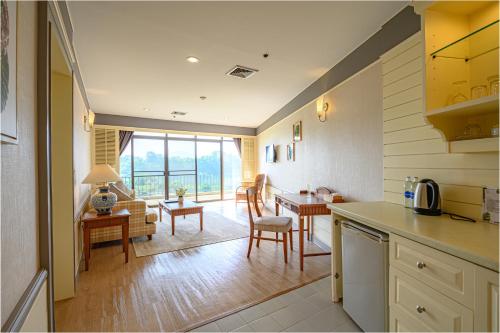 a kitchen and living room with a table and chairs at Eco Hotel by Thammasat in Bang Lamung