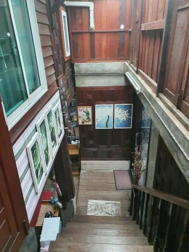 an overhead view of a staircase in a building with paintings at SolarCell walking street Homestay - โซล่าเซลล์ถนนคนเดินโฮมสเตย์ in Ban Nong Nam Khan